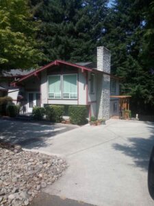 A Residential Colonial Red Gutter Installation by Affordable Roofing & Gutter Company in Lebanon, Oregon