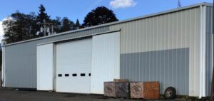 A Industrial White Gutter Installation by Affordable Roofing & Gutter Company in Salem, Oregon